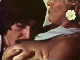 Experienced blonde with big boobs gets her pussy caressed by a guy with a mustachio in a classic retro video